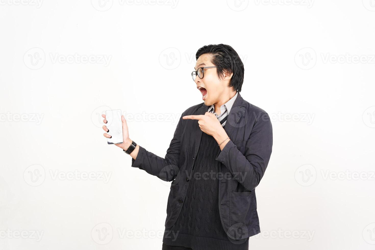 A man holding a phone and pointing at it photo