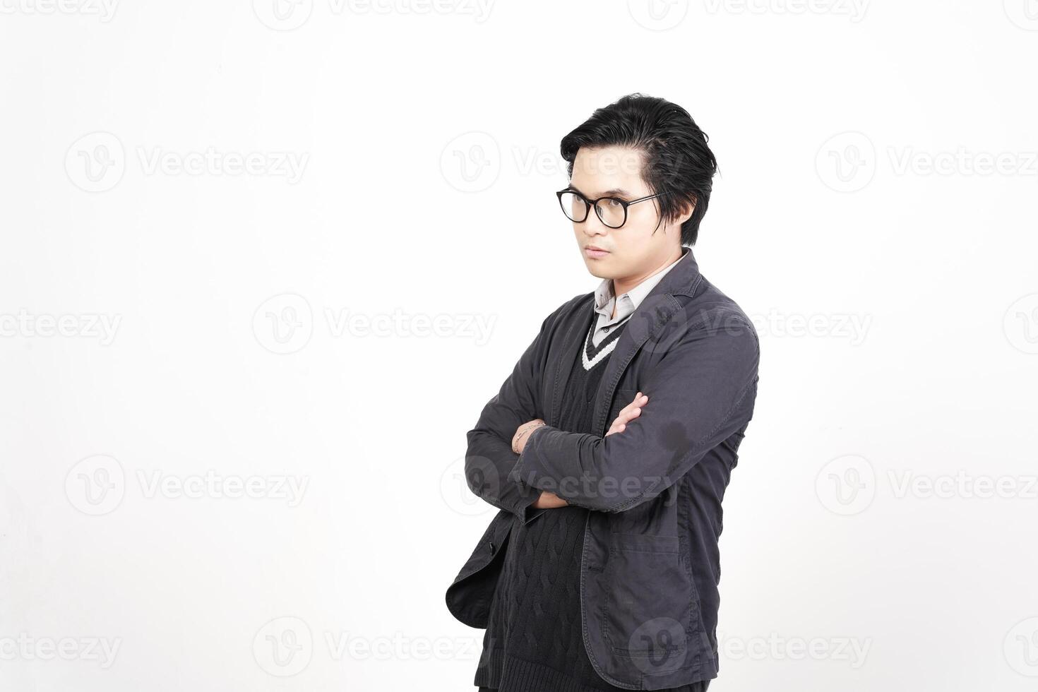 A man wearing glasses and a jacket standing with his arms crossed photo