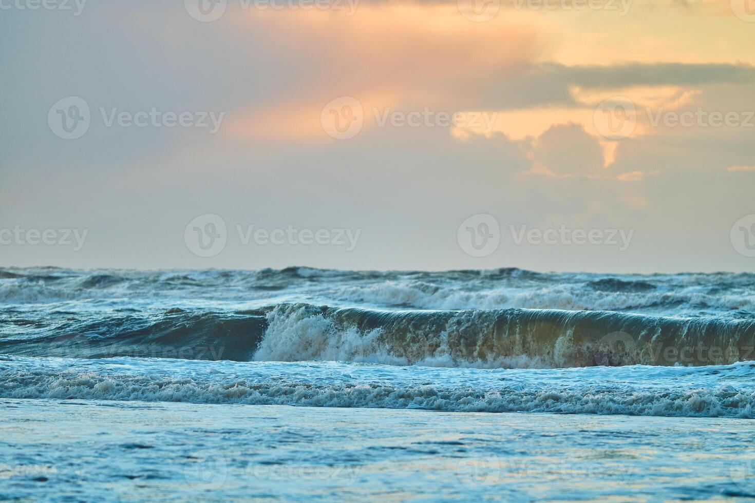 Sunset over north sea waves photo