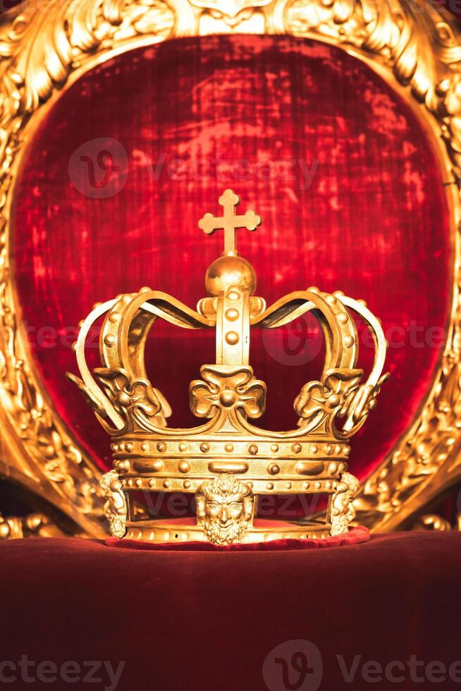 Ancient .crown on red velvet. Antique symbol of authority, luxury, monarchy, nobility photo