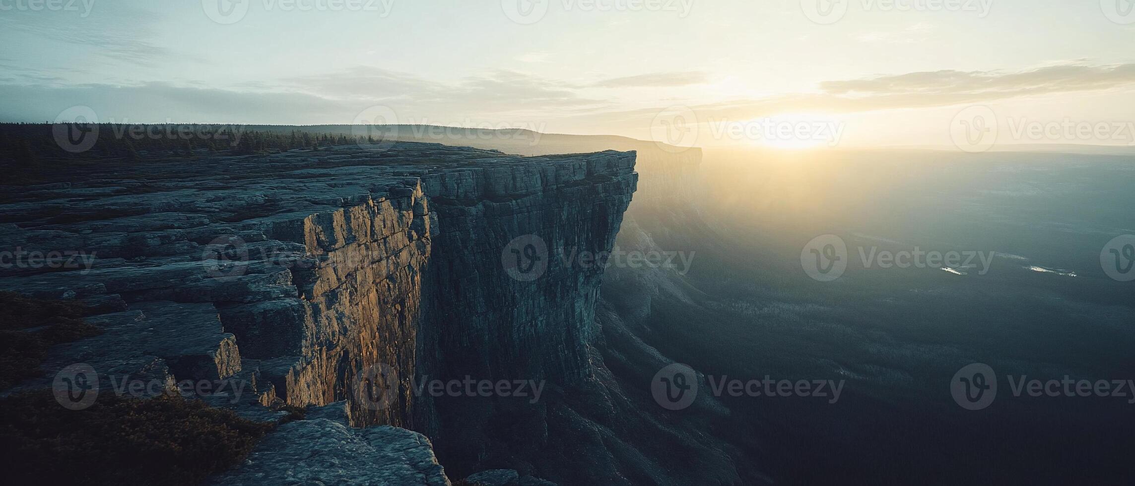 Sunset over a cliff, vast canyon. Background haze. Nature photo