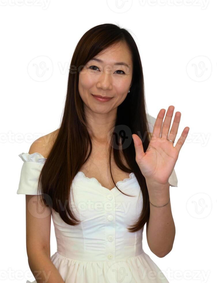 A woman in a white dress waving her hand photo