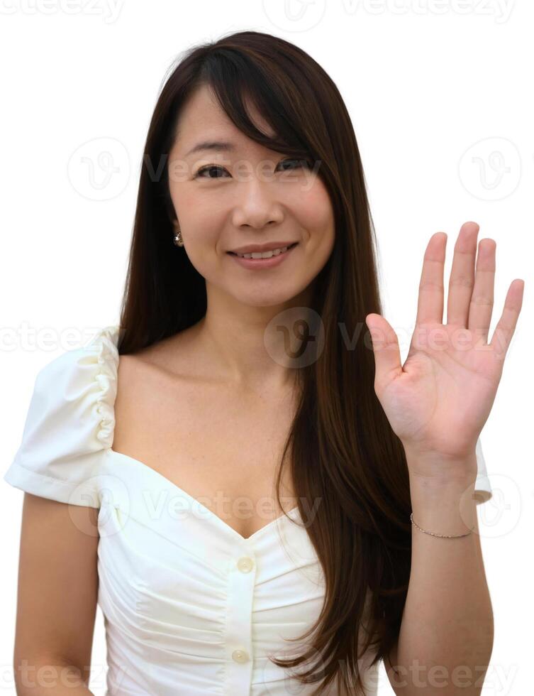 A woman with her hand up and a smile photo