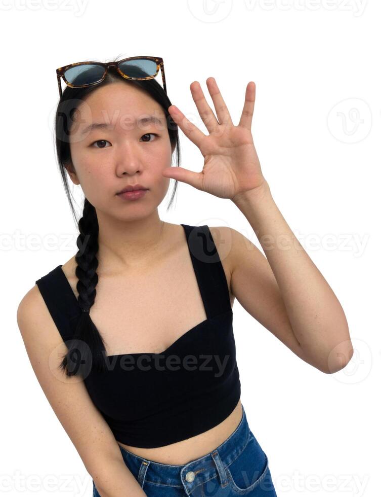 A woman in a crop top and sunglasses making the ok sign photo