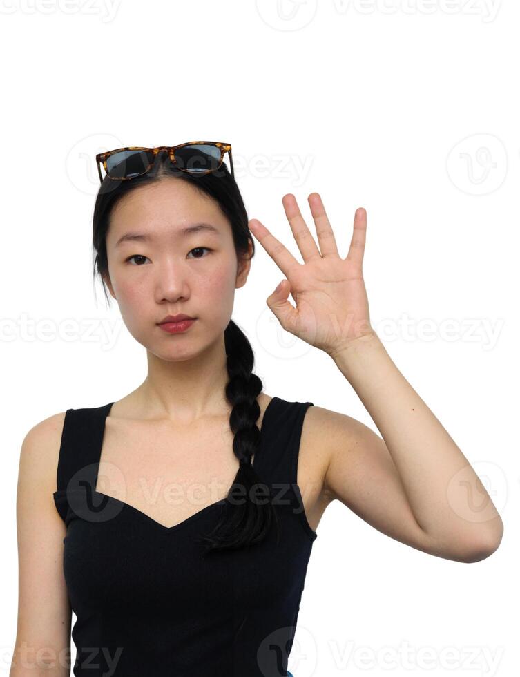 A woman with sunglasses making the ok sign photo