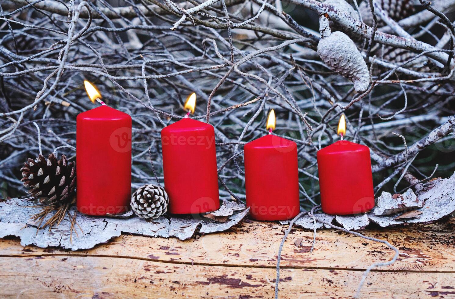 Four red burning advent candles as Catholic symbol of Christmas. Christmas decoration with burning candles for Advent time. greeting card concept photo
