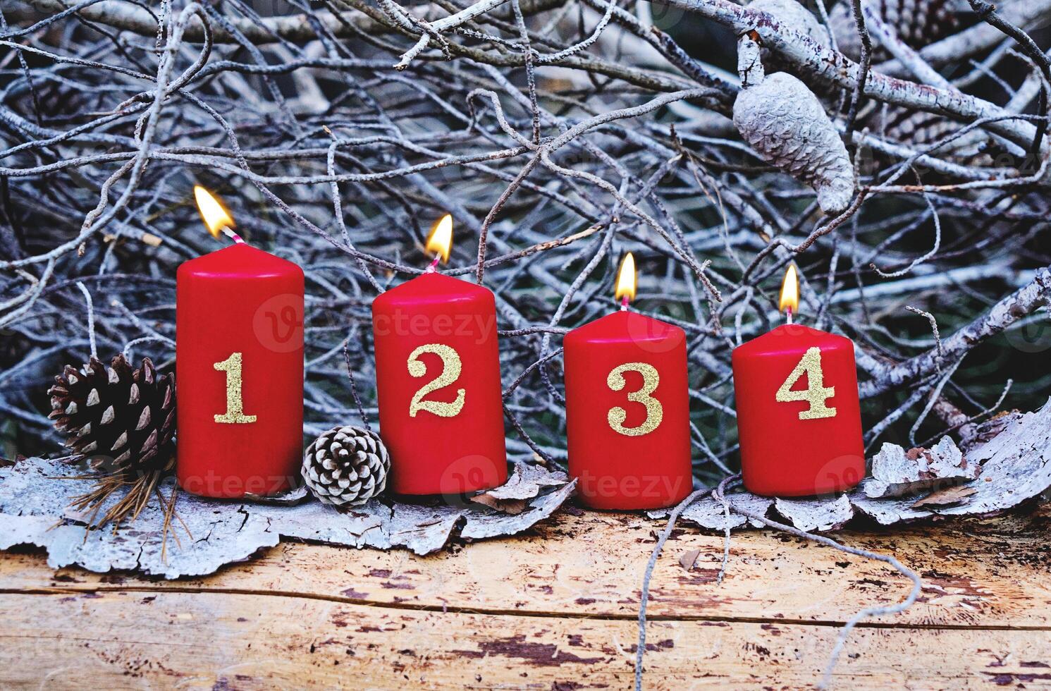 Four red advent candles with number as Catholic symbol of Christmas. Christmas decoration with burning candles for advent time photo