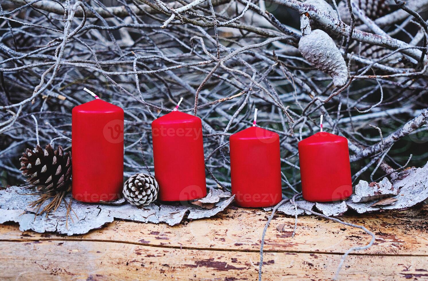 Four red advent candles as Catholic symbol of Christmas. Christmas decoration with burning candles for advent time greeting card photo