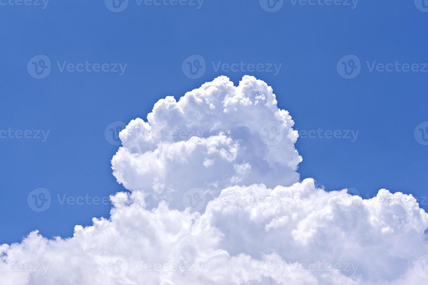 Large cumulus cloud on clear blue sky. Concept of environmental pollution photo