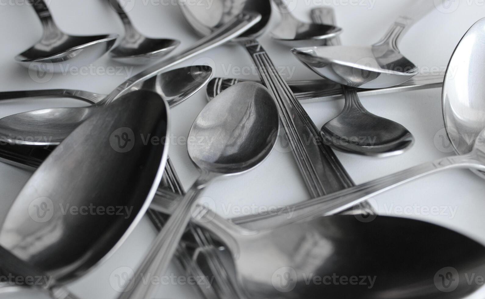 Mix Of Silvery Variety Size Spoons Closeup Angle View. Cutlery Spoons Set Concept Background photo