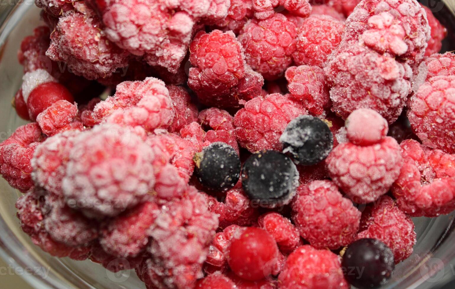 Detailed View Of Frozen Raspberry Fruits Mixed With Red And Black Currants photo