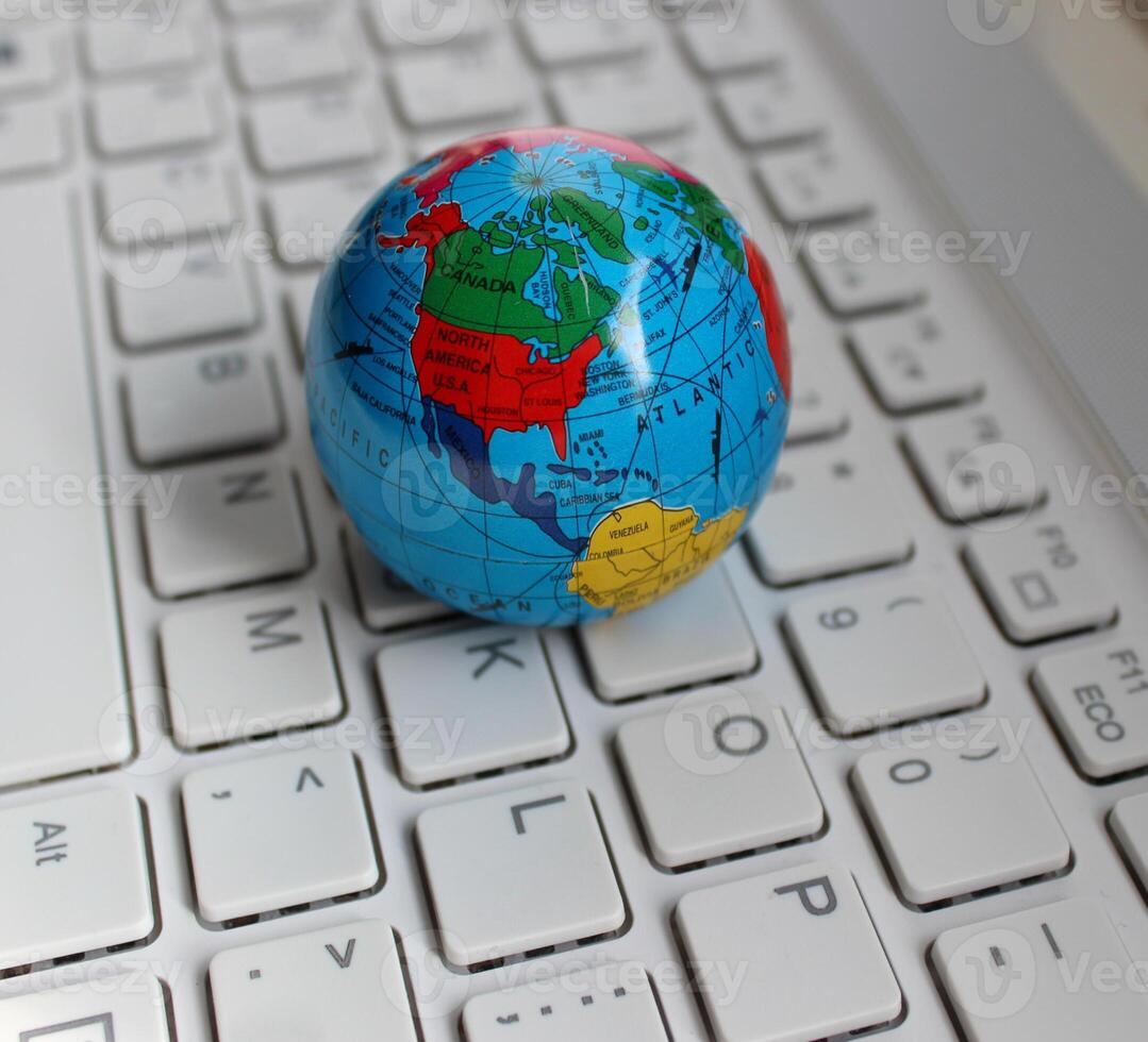 North America Continent Between Oceans Is Mapped On Small Globe On Computer Keyboard photo