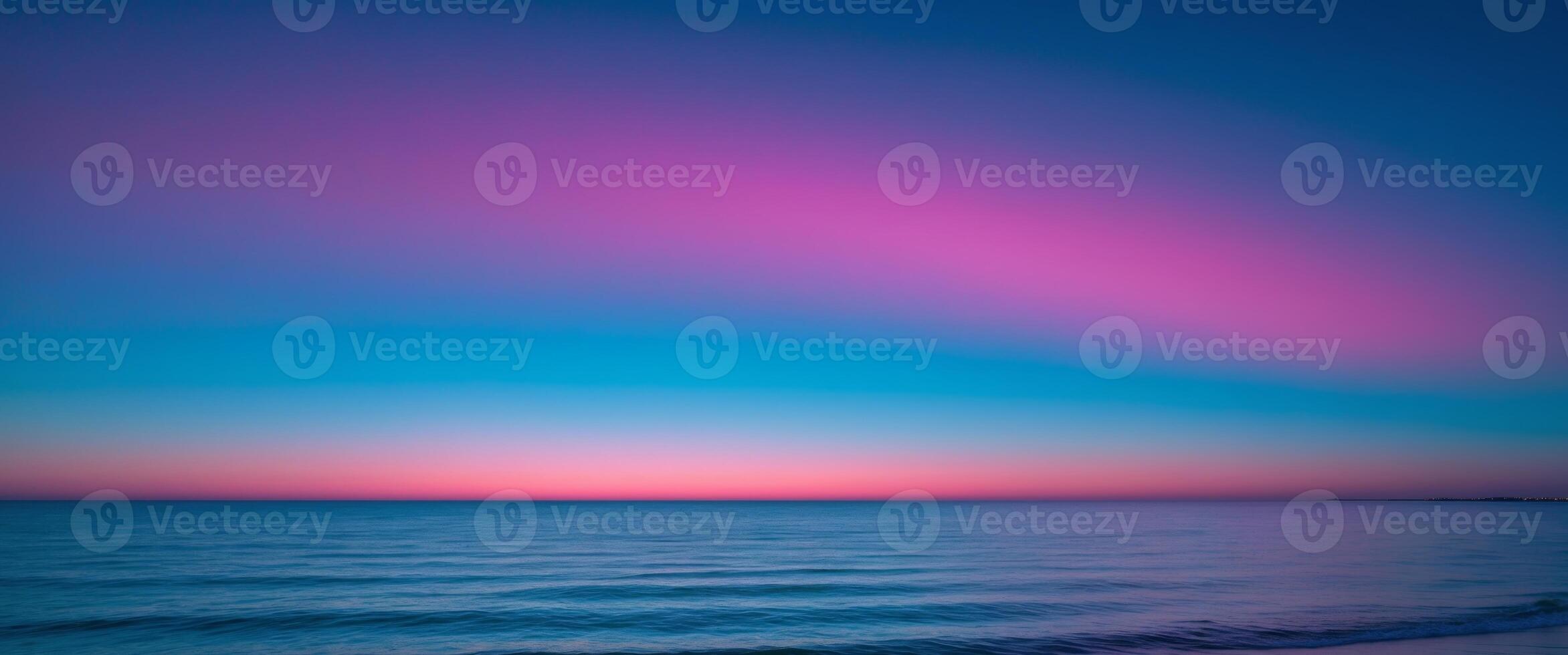 Colorful horizon with neon blue and pink gradient sky over tranquil ocean photo