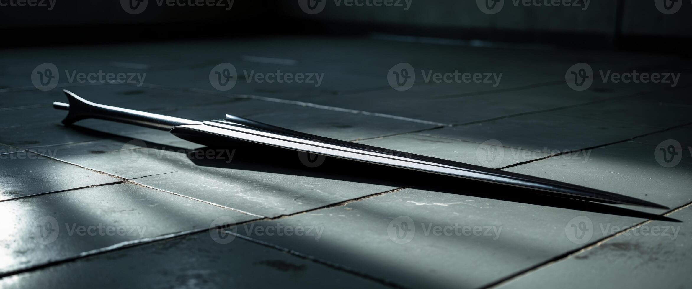 Spear or arrow with metal tip lying on a tiled floor in dramatic lighting. photo