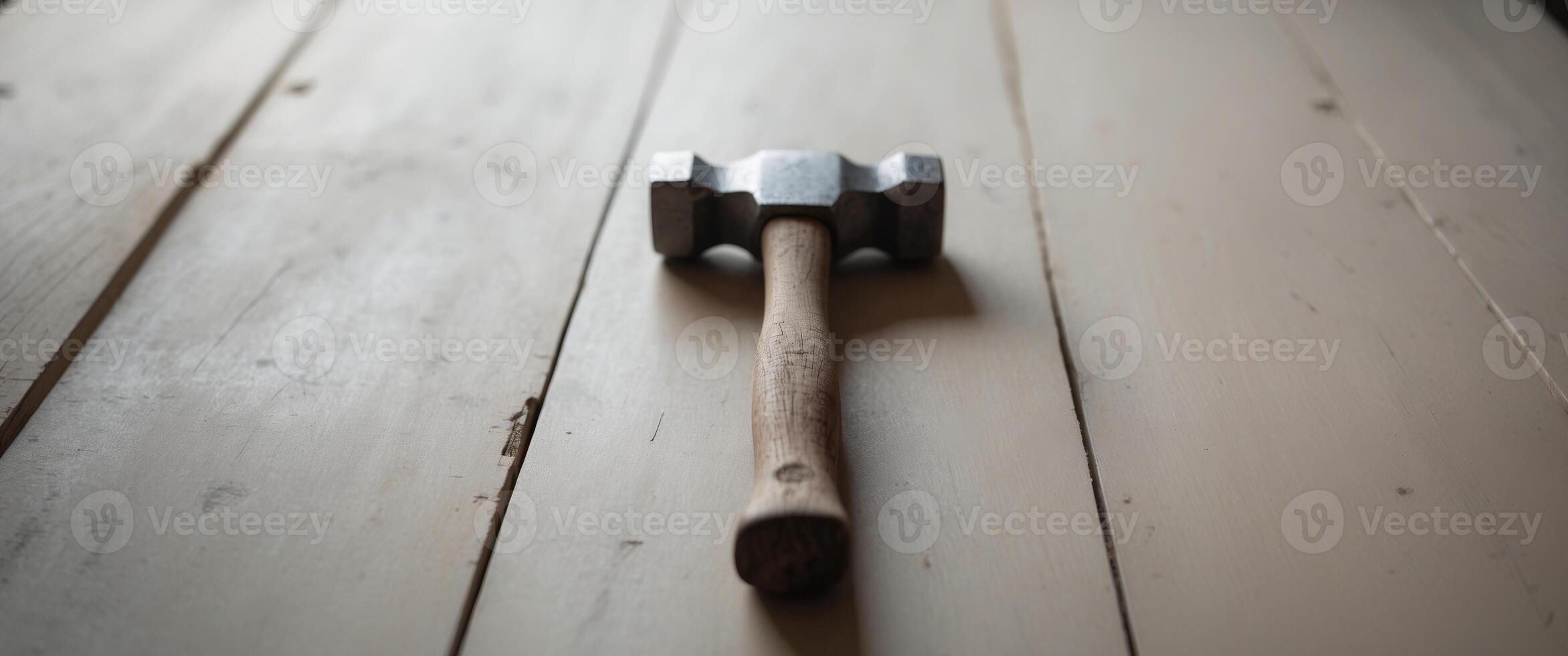 there is a hammer that is on top of a table photo