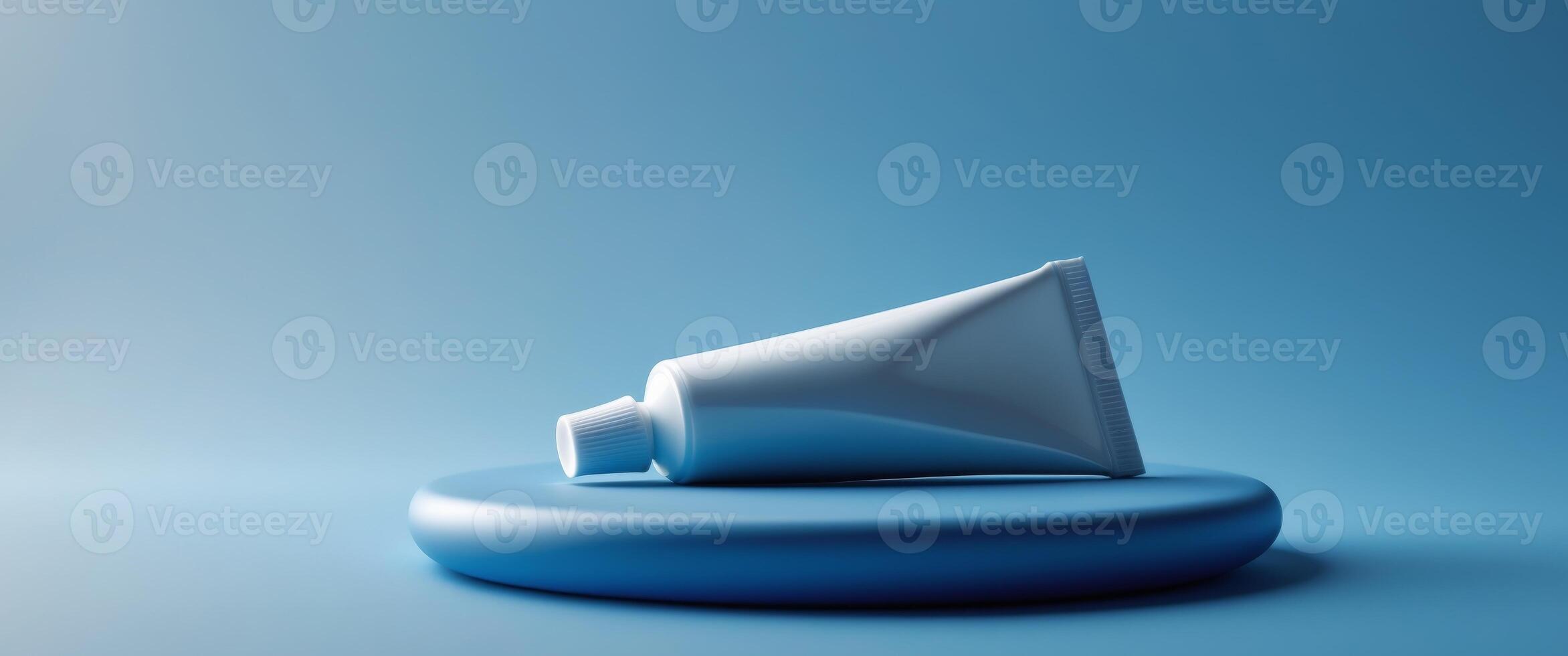 a close up of a tube of toothpaste on a blue surface photo