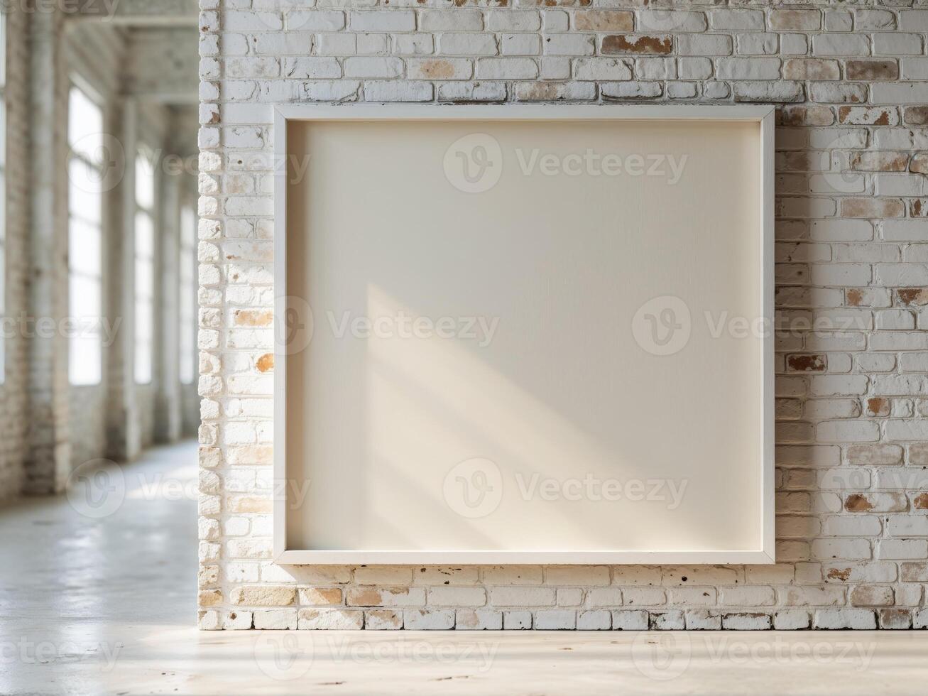 Empty white frame on a brick wall in an empty room photo