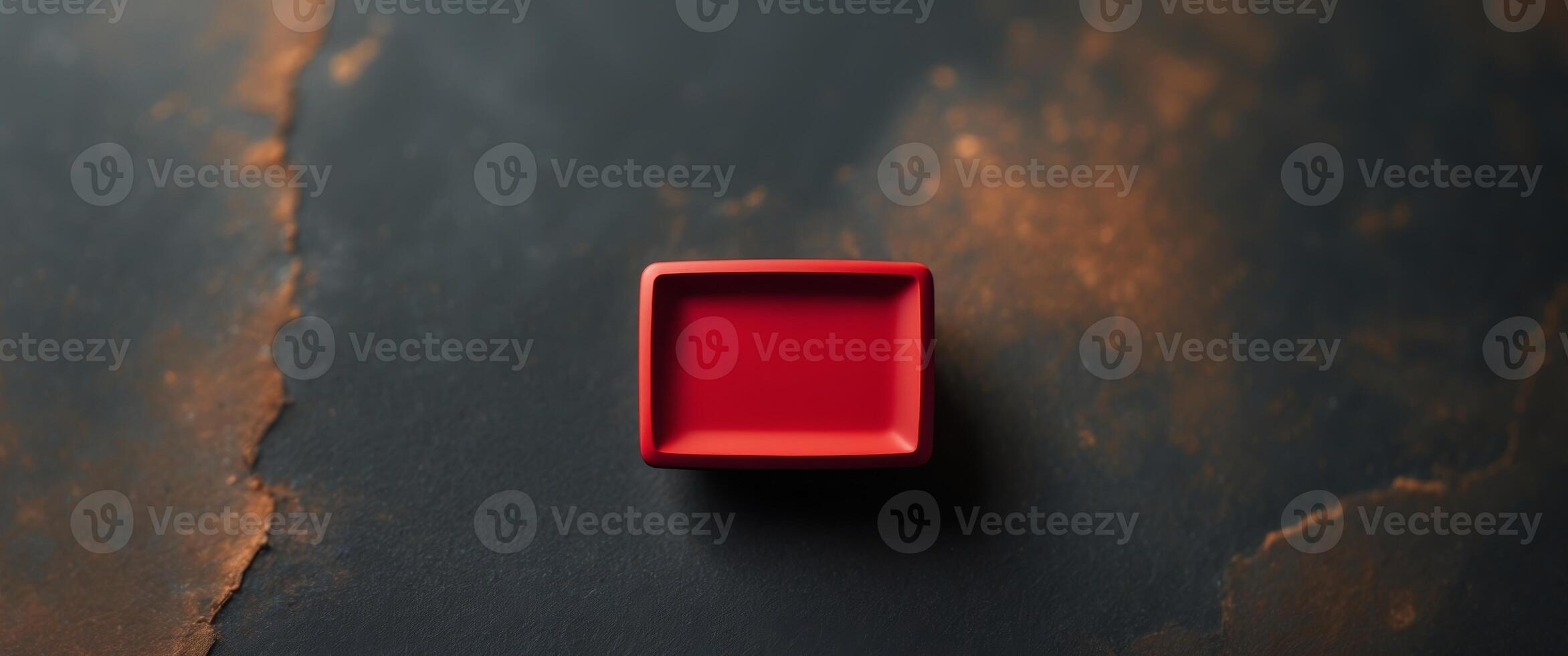 A red square on a black surface photo