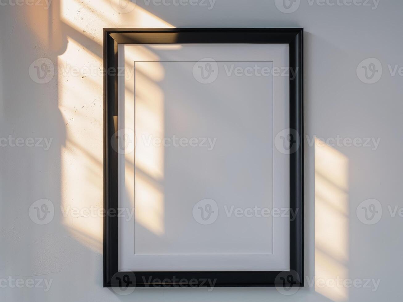 Black Framed Picture Frame Mockup on White Wall with Natural Light and Shadows photo