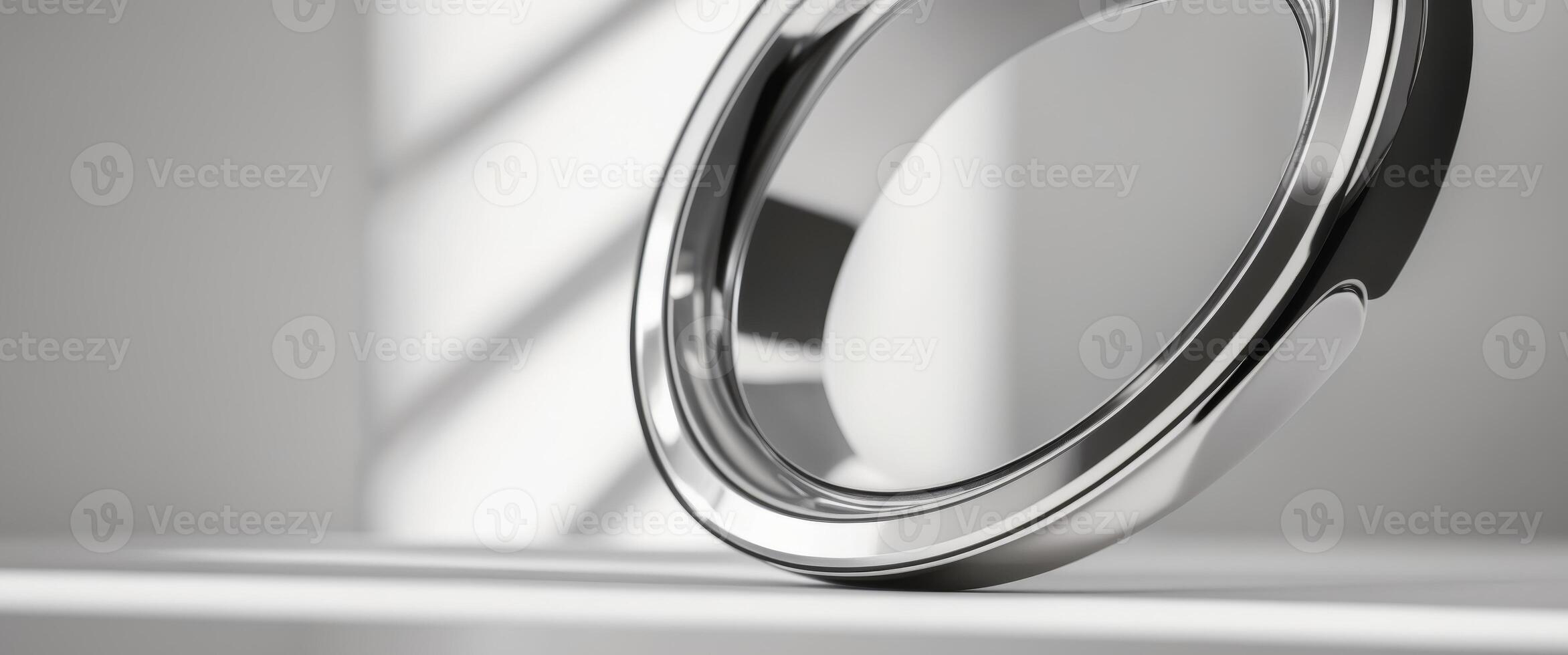 A ring is sitting on a table in front of a window photo