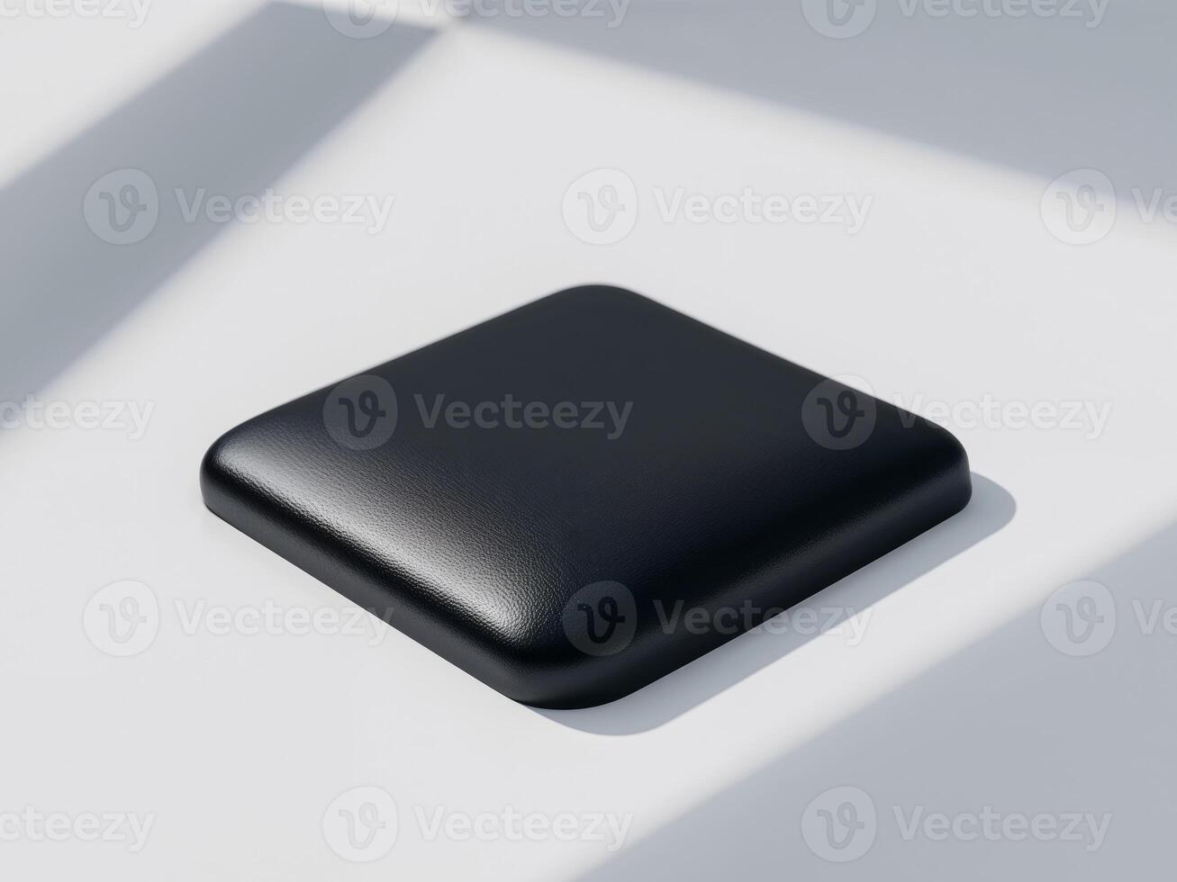 A black square object sitting on a white surface photo