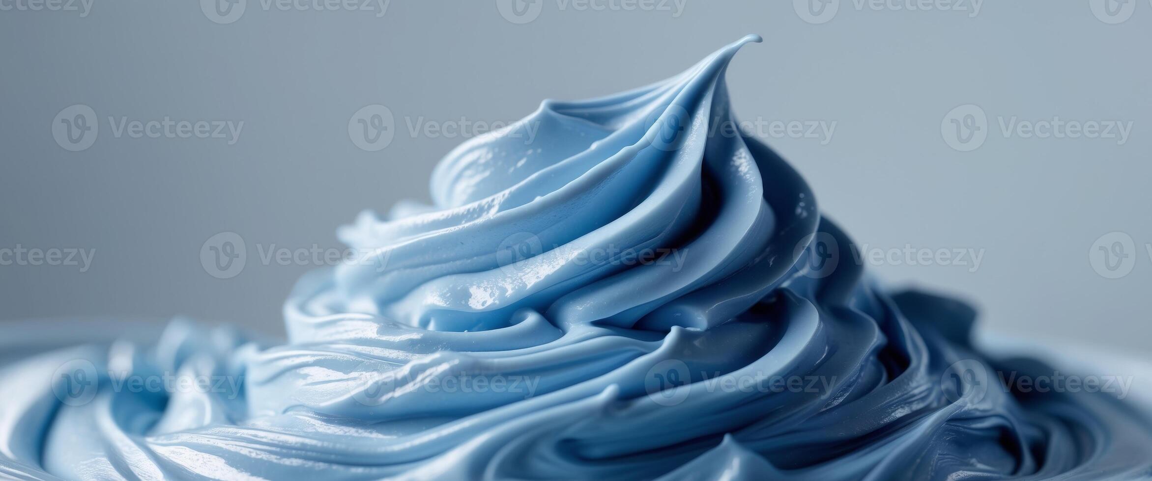 A close up of a blue frosting on a white surface photo