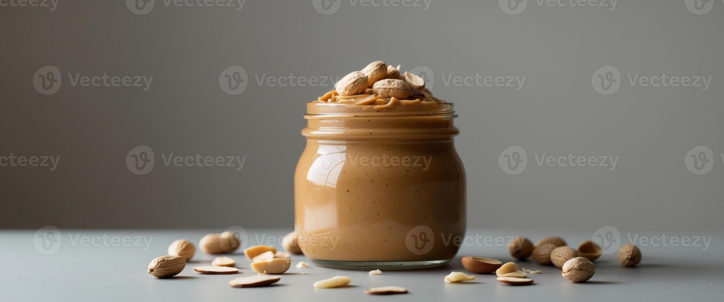 Peanut Butter in Glass Jar with Peanuts and Almonds. photo