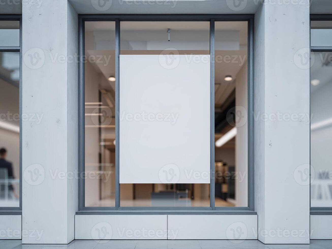 Modern office or shop building exterior with blank white mockup poster in window display for branding and advertisement. photo