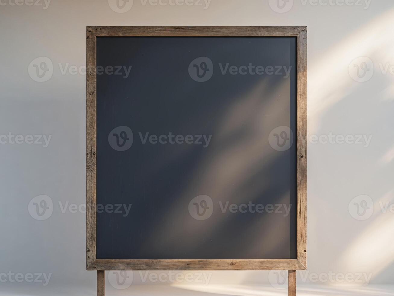 A blank blackboard with a wooden frame stands ready for classroom education photo