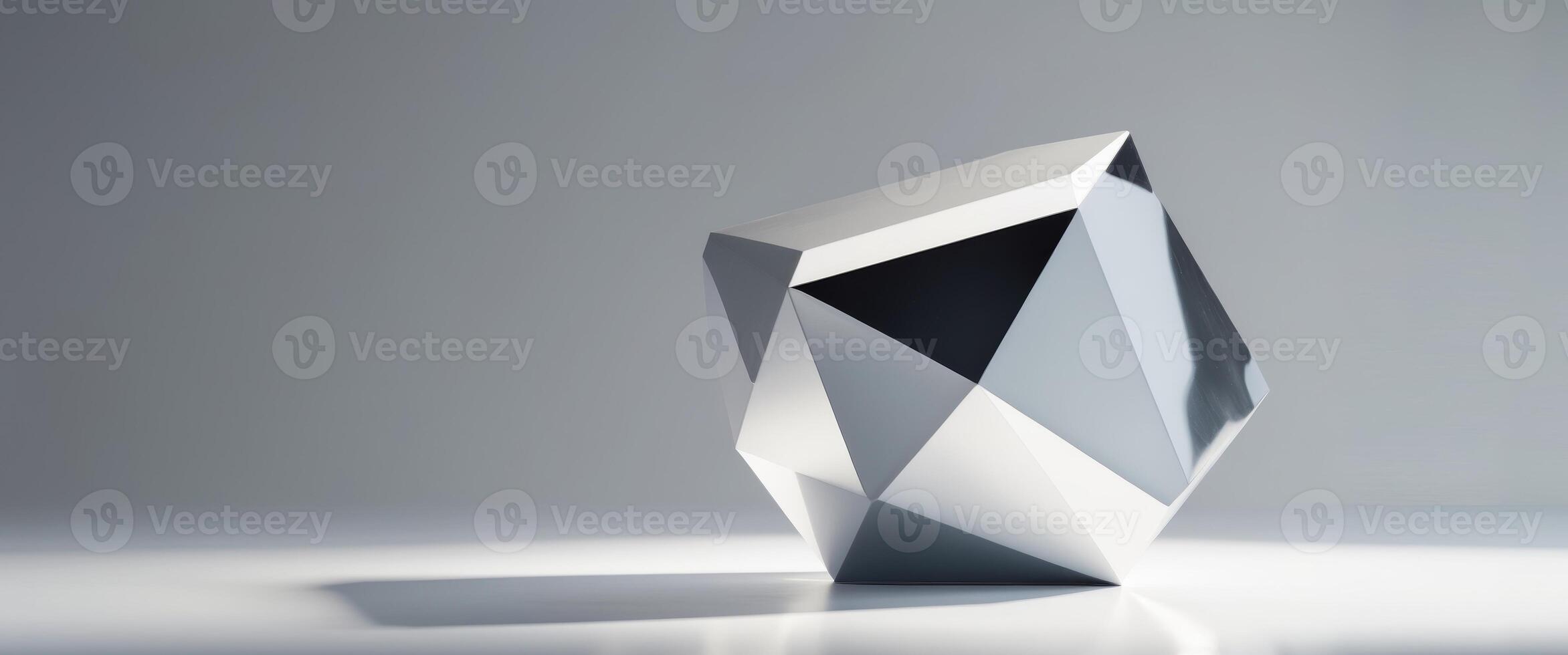 A faceted silver object rests on a flat surface. photo