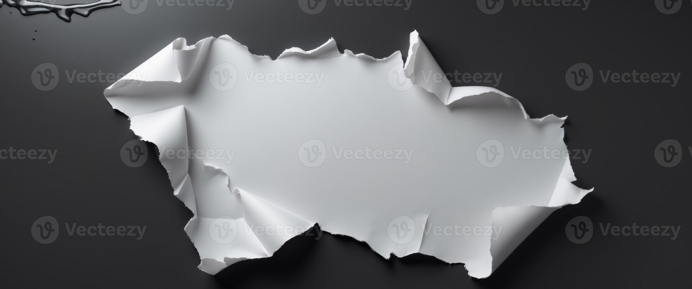 Torn white paper on black background for creative design and text placement. photo