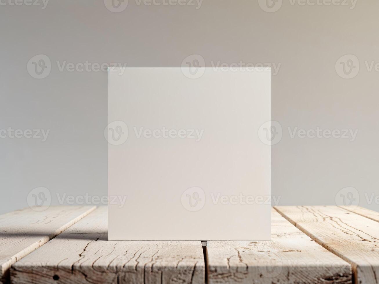Blank White Square Card Mockup On Wooden Table photo