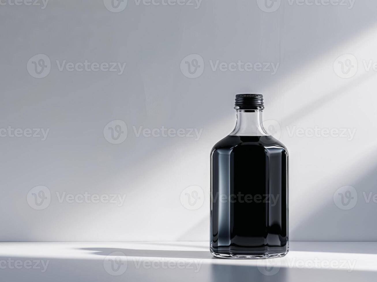 Clear Pixel Visual of a Bottle of Black Liquid Sits in Front of a White Wall photo