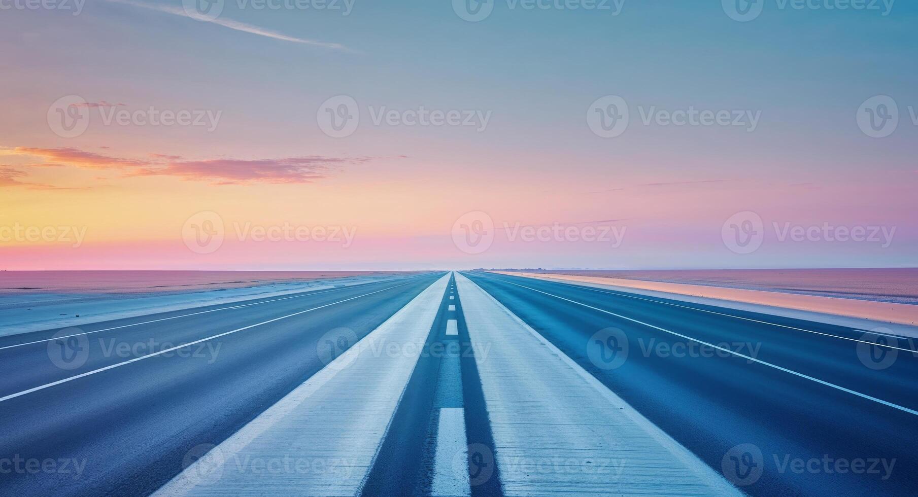 An empty highway with a sunset in the background photo