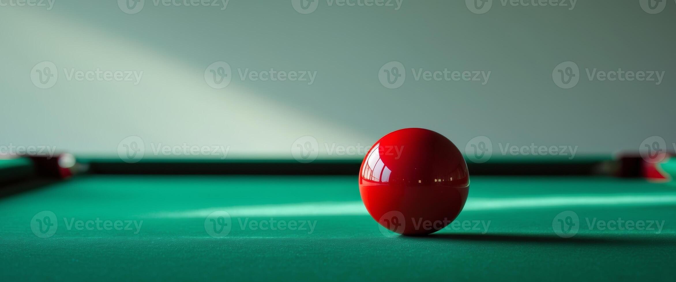 A red ball on a green pool table photo