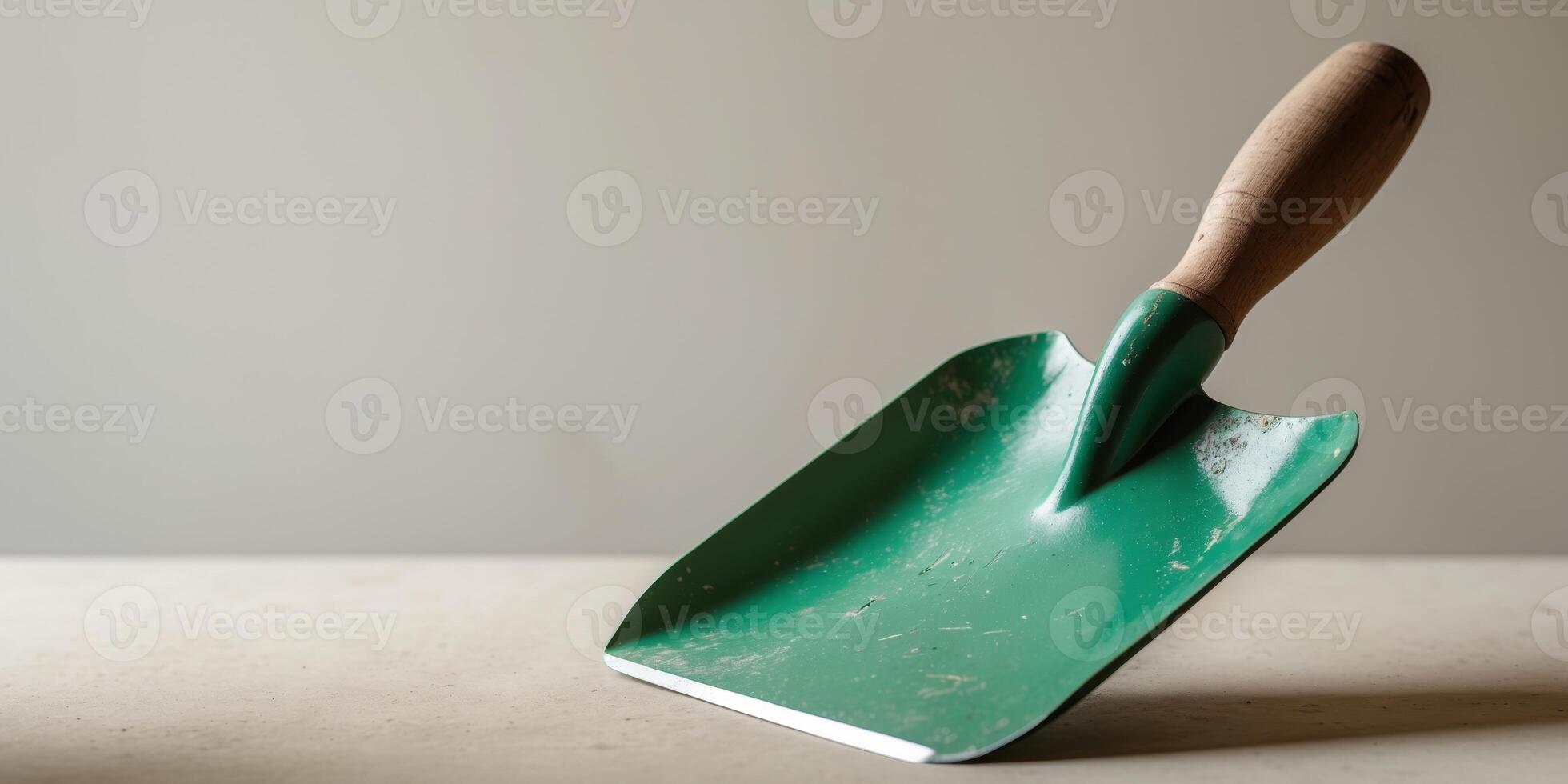Green Hand Trowel with Wood Handle for Gardening Tasks. photo