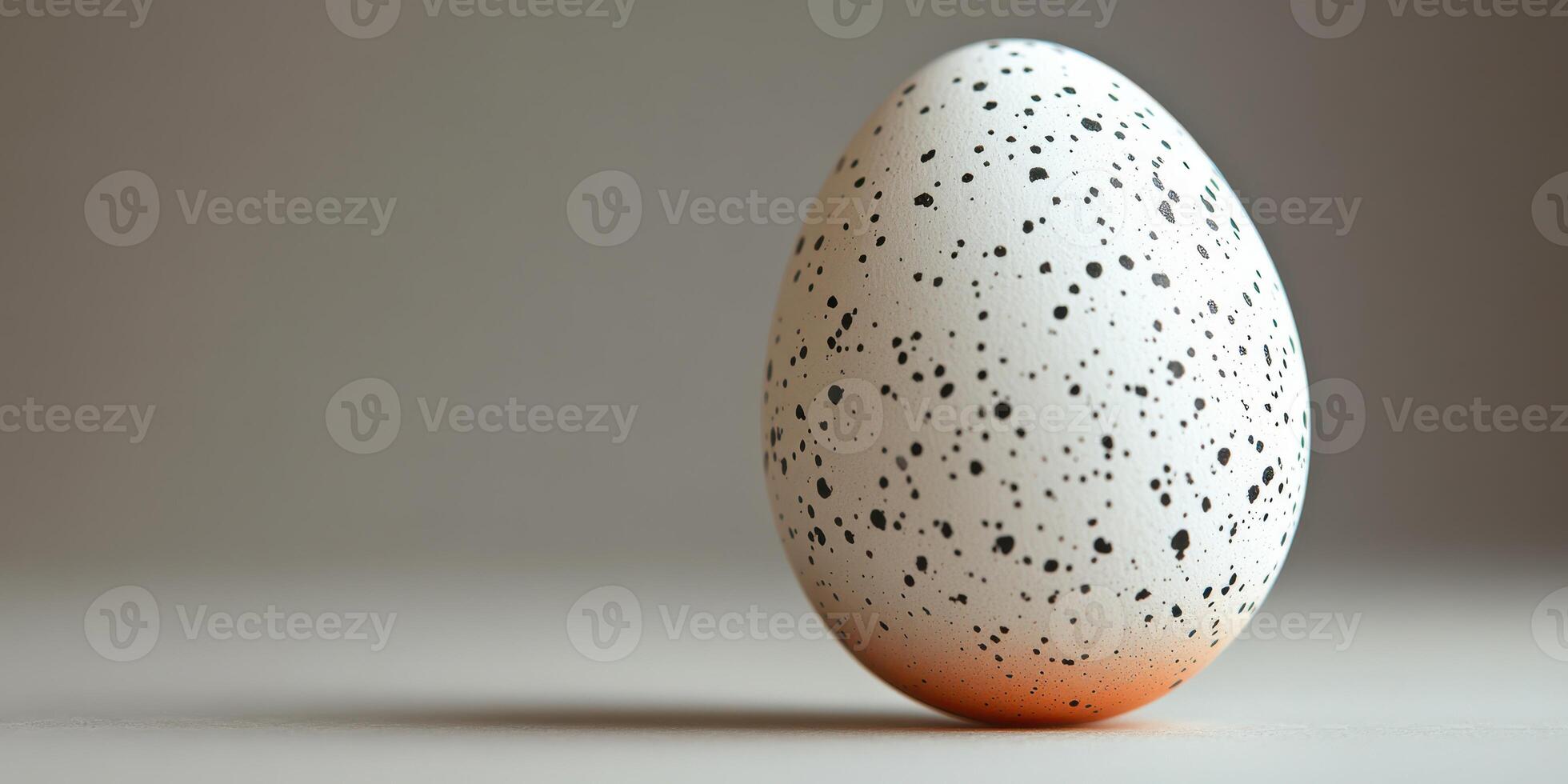 Speckled egg resting on a neutral surface showcasing intricate details and textures photo