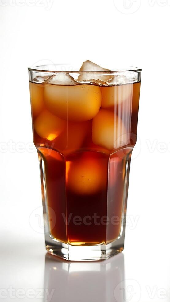 Refreshing drink in a clear glass filled with ice cubes on a light background photo