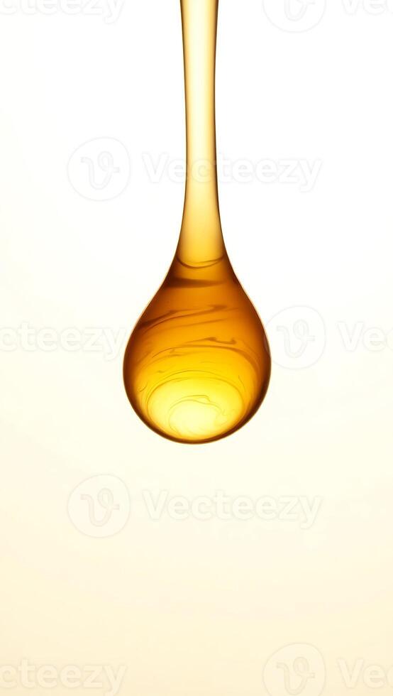 Closeup of a golden droplet suspended in the air with a blurred background photo