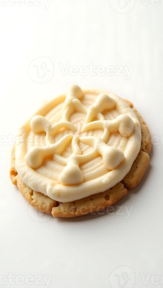 Closeup of a decorated cookie featuring intricate frosting design on a soft base photo