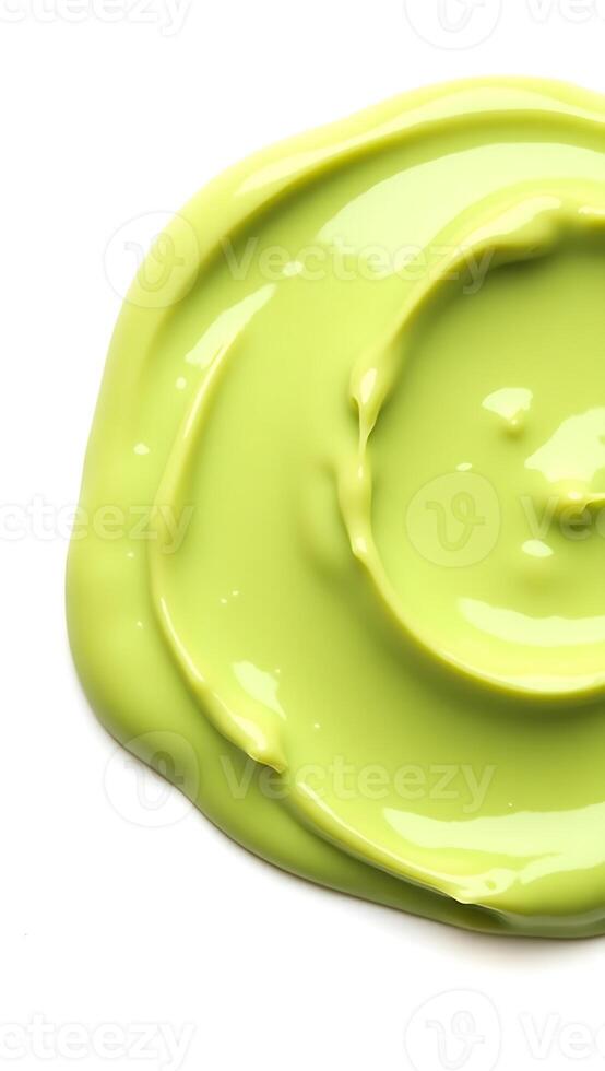 Closeup of bright green paint swirl on a clean surface with smooth texture photo