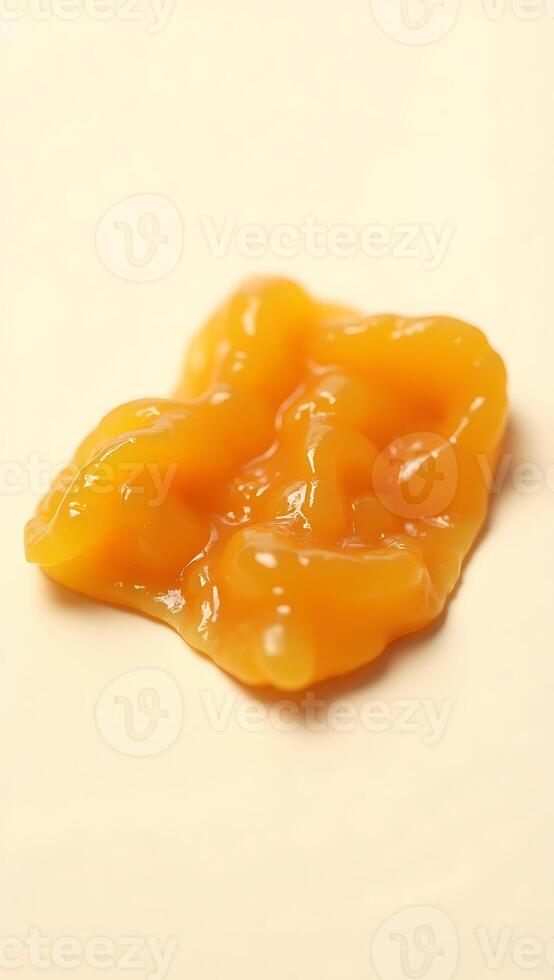 Detailed closeup of a bright orange substance on a flat surface photo