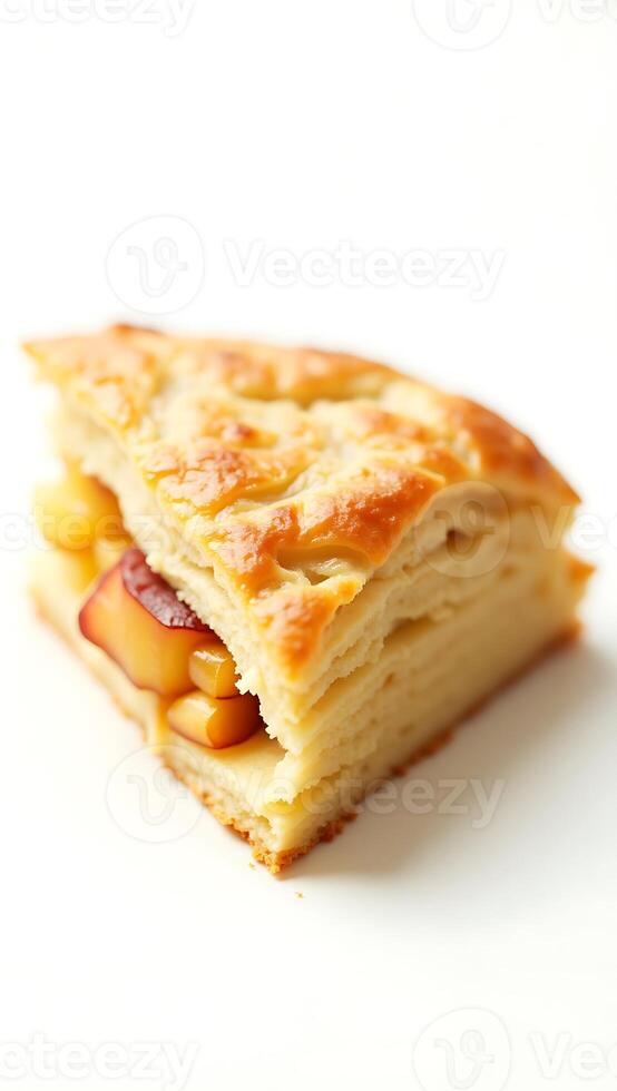 Extreme closeup of a flaky pastry with apple filling on a plain background photo