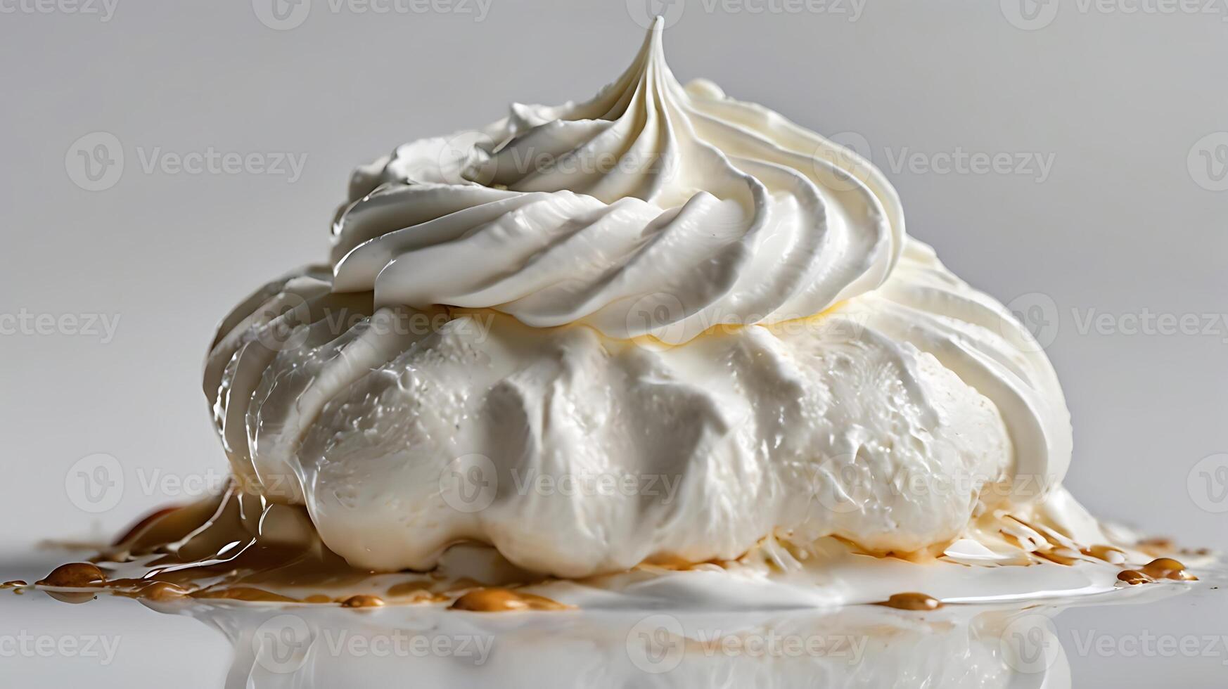 Closeup view of a dollop of whipped cream with caramel drizzle on a smooth surface photo