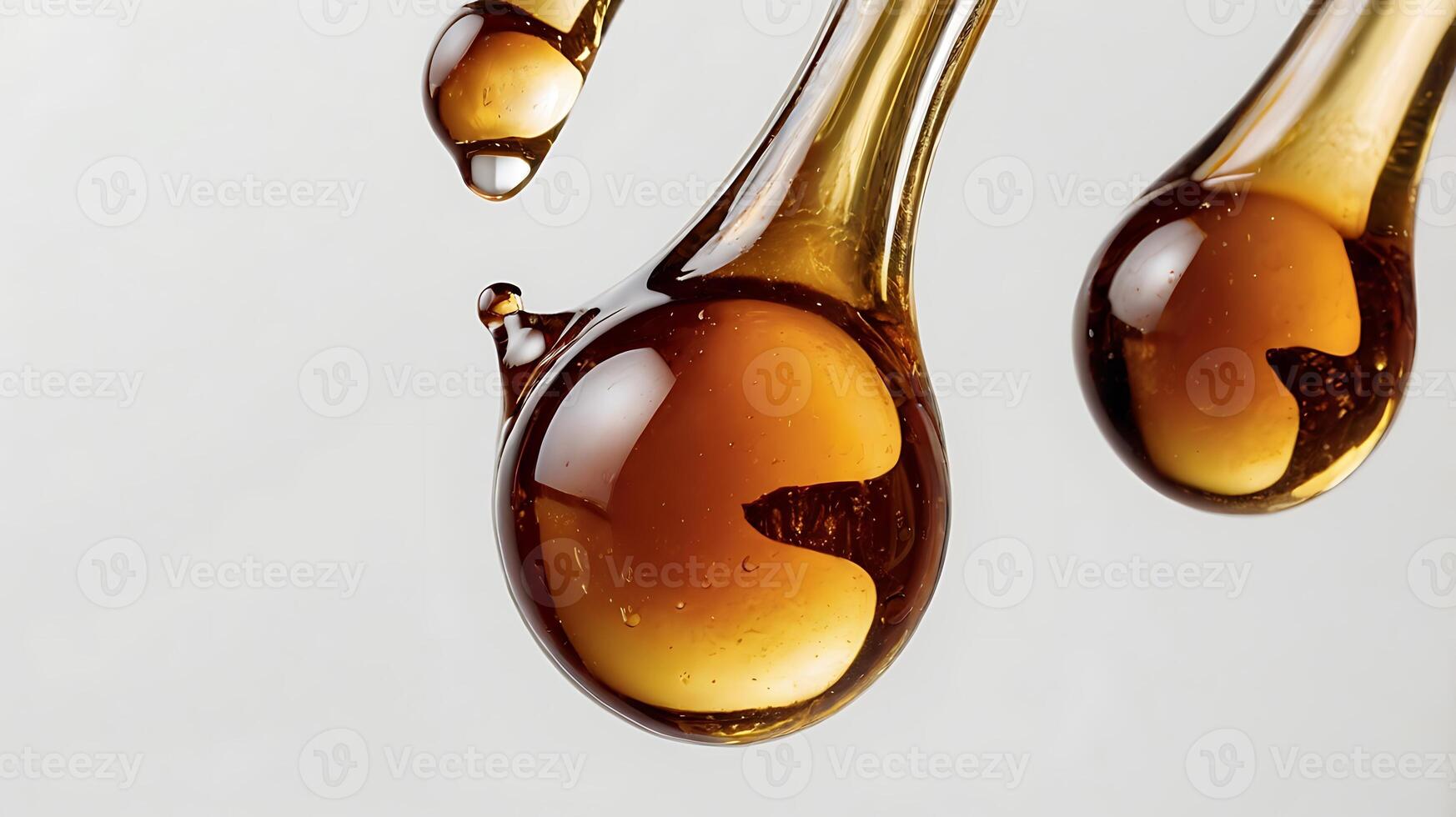 Extreme closeup of a drop of maple syrup showcasing its thick texture and rich color photo
