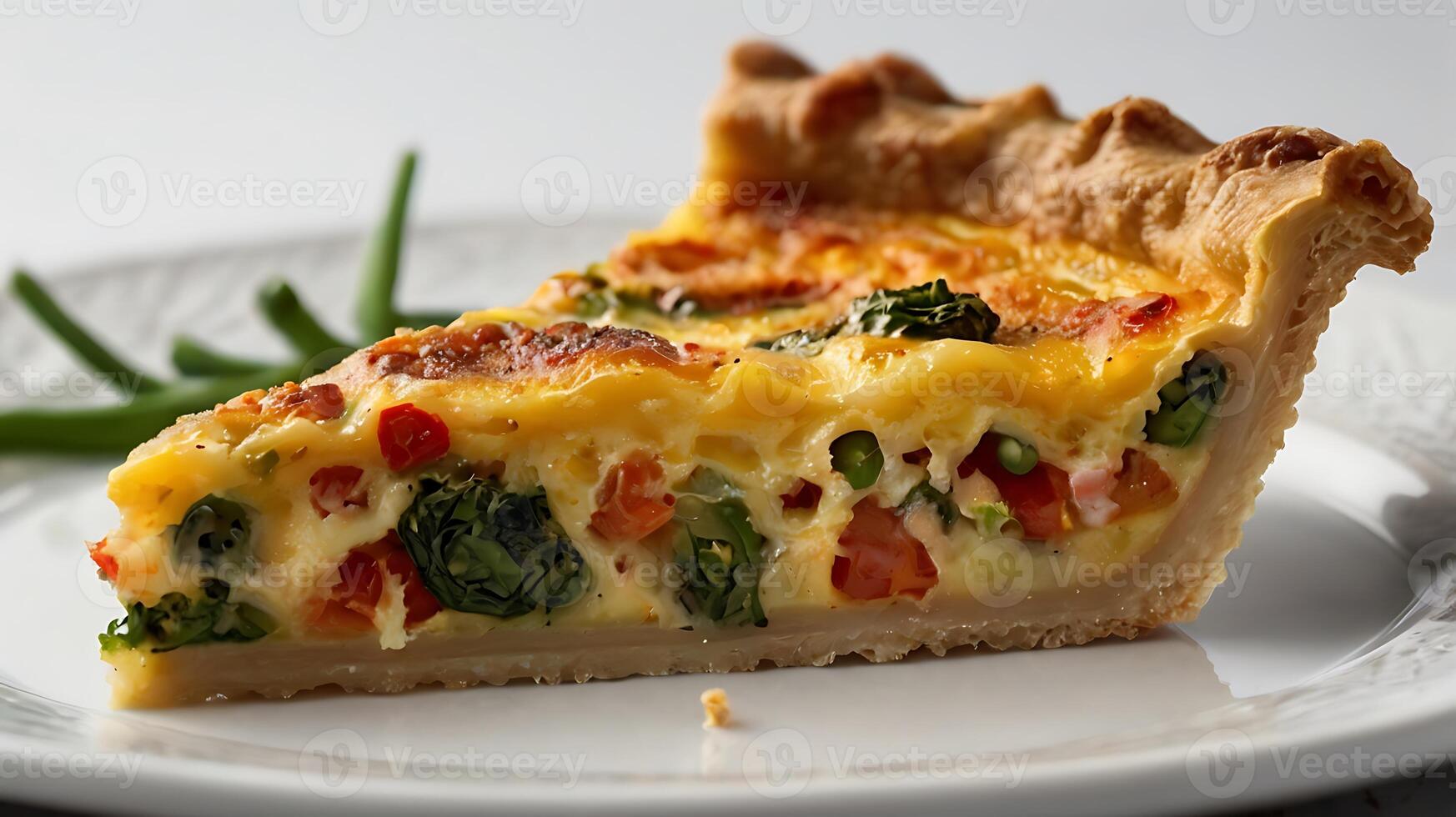 Closeup view of a delicious slice of quiche with fresh vegetables on a plate photo