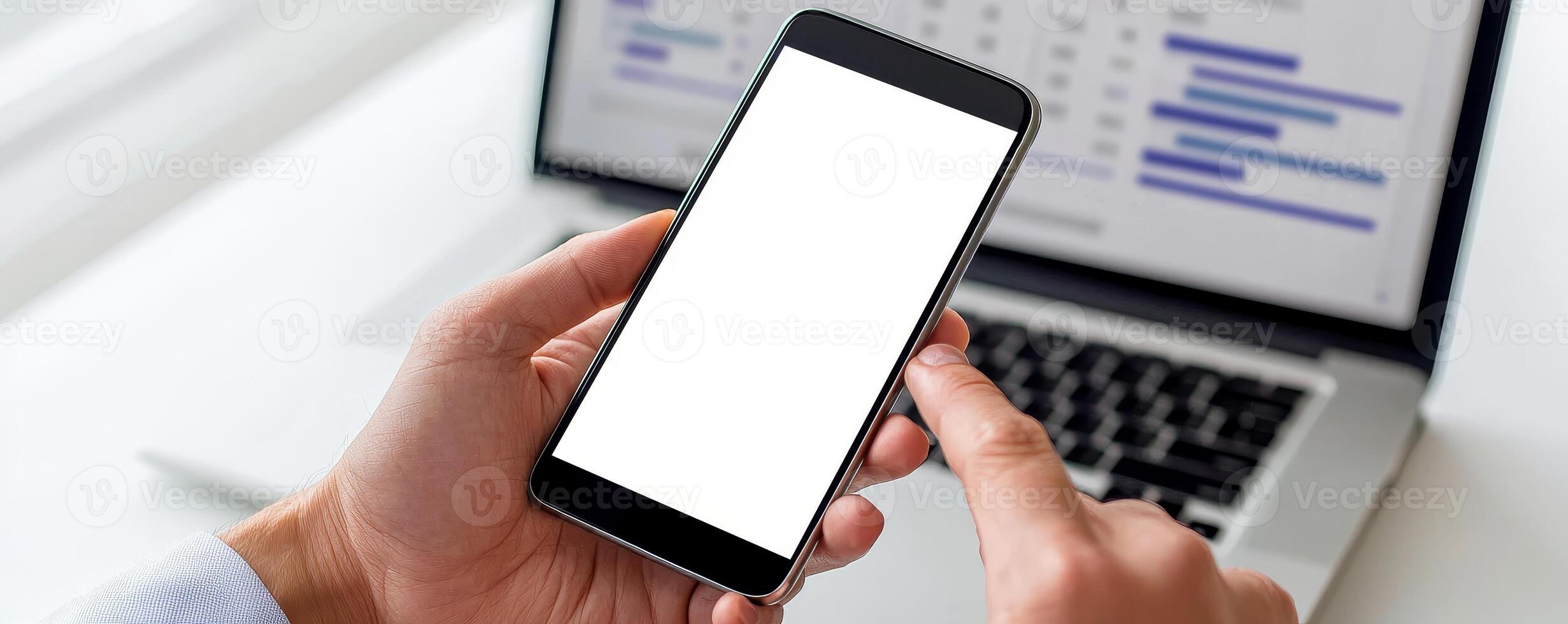 Marketing analytics performance ROI concept. Blank smartphone held in hand with a computer screen in the background. photo