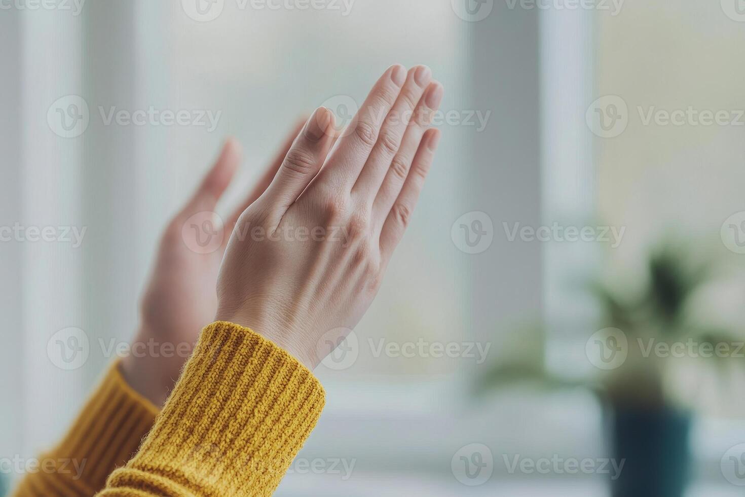 Clapping hands in a cozy setting with a soft focus background. photo