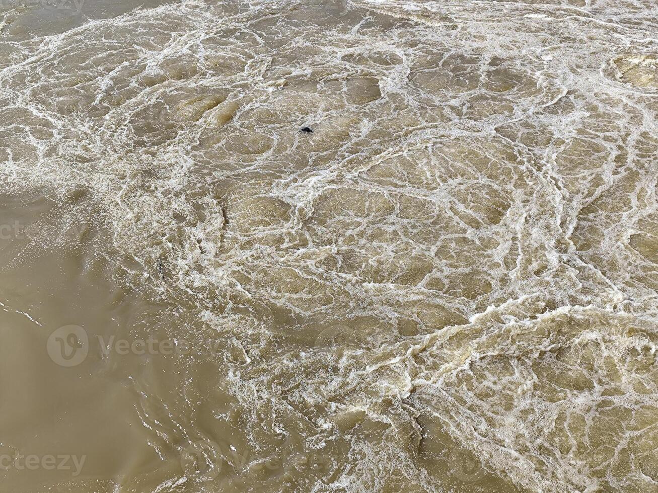 Muddy River Current Creating Natural Swirling Foam photo