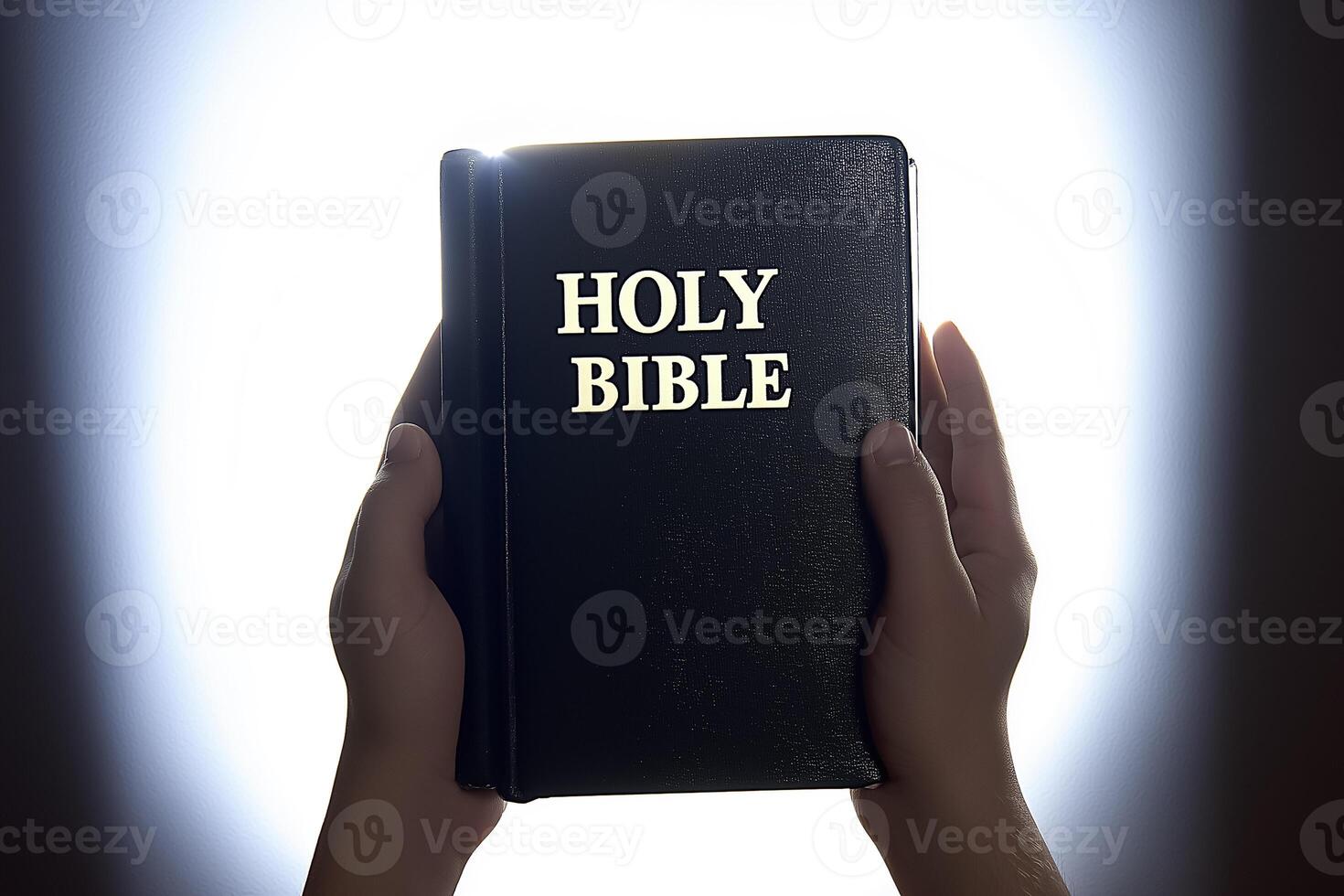 Holy bible in hands of person with light background photo